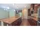 Well-lit kitchen boasts a large island, granite countertops, stainless steel appliances and brown cabinets at 536 Rockcastle Dr, Cary, NC 27519
