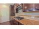 Kitchen detail showcases granite countertops, tile backsplash, stainless range, and dark wood cabinetry at 536 Rockcastle Dr, Cary, NC 27519
