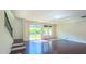 Spacious living room features hardwood floors, natural light, access to the backyard and staircase at 536 Rockcastle Dr, Cary, NC 27519