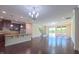 Open-concept living space with hardwood floors and modern lighting, seamlessly connecting the kitchen to the living area at 536 Rockcastle Dr, Cary, NC 27519