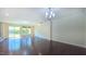 Hardwood floors and neutral walls create an open living space with glass doors, windows, and stylish light fixture at 536 Rockcastle Dr, Cary, NC 27519