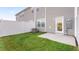 Well-kept backyard with a patio, lawn, and a privacy fence at 5556 Henley Ridge Dr, Graham, NC 27253