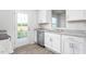 Close-up of kitchen with stainless steel dishwasher, sink, white cabinets, and granite countertops at 5556 Henley Ridge Dr, Graham, NC 27253