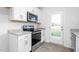 Equipped kitchen featuring stainless steel appliances and white cabinets with granite countertops at 5556 Henley Ridge Dr, Graham, NC 27253