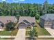 An aerial view showcases a well-maintained property with mature trees and manicured lawns in a suburban neighborhood at 601 Minerva Dale Dr, Fuquay Varina, NC 27526