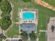 Overhead shot of the neighborhood pool and playground, surrounded by manicured green spaces and parking areas at 601 Minerva Dale Dr, Fuquay Varina, NC 27526