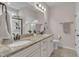 Bright bathroom boasts granite counters, dual sinks, white cabinetry, and a glass-enclosed shower at 601 Minerva Dale Dr, Fuquay Varina, NC 27526