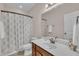 Bathroom featuring a single sink vanity, shower/tub combo, and modern fixtures at 601 Minerva Dale Dr, Fuquay Varina, NC 27526