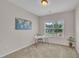 Bedroom featuring a world map, a modern desk, and large windows providing natural light at 601 Minerva Dale Dr, Fuquay Varina, NC 27526