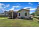 Back exterior view of the home featuring a screened porch, tidy landscaping, and adjacent homes in the community at 601 Minerva Dale Dr, Fuquay Varina, NC 27526