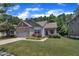 Charming single-story home with stone accents, a manicured lawn, and vibrant flower beds under a beautiful sky at 601 Minerva Dale Dr, Fuquay Varina, NC 27526