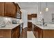 Stylish kitchen with stainless steel appliances, granite countertops, dark wood cabinets, and modern fixtures at 601 Minerva Dale Dr, Fuquay Varina, NC 27526