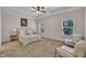Serene bedroom with tray ceilings, carpet, neutral tones, sitting area, and natural light from two windows at 601 Minerva Dale Dr, Fuquay Varina, NC 27526