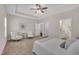 Bright and spacious main bedroom featuring tray ceilings, carpet floors, and ensuite bathroom access at 601 Minerva Dale Dr, Fuquay Varina, NC 27526
