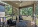 Relaxing screened porch with ceiling fan, comfortable seating, decorative rug, and a view of the lush backyard at 601 Minerva Dale Dr, Fuquay Varina, NC 27526