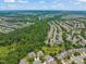 Aerial view shows a neighborhood and densely populated homes surrounded by lush trees and foliage at 606 Corrigan Way, Cary, NC 27519