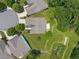 An aerial view showcases a home with a well-manicured lawn, trees and a backyard pond at 606 Corrigan Way, Cary, NC 27519