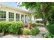 The rear of the house featuring a fountain in a landscaped yard with large windows at 606 Corrigan Way, Cary, NC 27519
