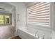 Spa tub in light, bright bathroom with neutral colors and view to bedroom at 606 Corrigan Way, Cary, NC 27519