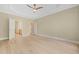 Open bedroom with hardwood floors and view to ensuite bathroom at 606 Corrigan Way, Cary, NC 27519