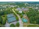 Beautiful aerial view of the community clubhouse, tennis courts, putting green, and recreational amenities at 606 Corrigan Way, Cary, NC 27519
