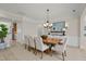 A dining room features a wood table, upholstered chairs, a chandelier, and wainscoting at 606 Corrigan Way, Cary, NC 27519