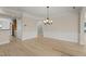 A dining room featuring hardwood floors, a chandelier, wainscoting, and ample space at 606 Corrigan Way, Cary, NC 27519