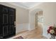 Inviting foyer with hardwood floors, elegant wainscoting, and an open view to the living spaces at 606 Corrigan Way, Cary, NC 27519
