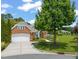 A lovely brick home with a two-car garage, landscaped yard, and well-maintained lawn on a sunny day at 606 Corrigan Way, Cary, NC 27519