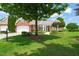 Beautiful brick home featuring an attached garage, landscaped yard, and a well-manicured lawn on a sunny day at 606 Corrigan Way, Cary, NC 27519
