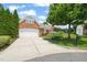 Brick home boasts an attached garage, complemented by lush landscaping and a neatly manicured lawn at 606 Corrigan Way, Cary, NC 27519