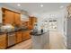 Kitchen with wood cabinets, granite countertops, stainless steel appliances, and hardwood floors at 606 Corrigan Way, Cary, NC 27519