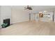 Open-concept living area with a fireplace, hardwood floors, and an open view to the kitchen at 606 Corrigan Way, Cary, NC 27519