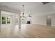 A spacious living room features hardwood floors, many windows, and a decorative fireplace at 606 Corrigan Way, Cary, NC 27519