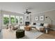 Bright living room featuring a fireplace, modern furniture, and large windows overlooking the outdoors at 606 Corrigan Way, Cary, NC 27519