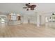 Bright and open living space featuring hardwood floors, a fireplace, and an open view to the kitchen and dining area at 606 Corrigan Way, Cary, NC 27519