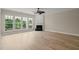 Spacious living room with a fireplace, neutral color palette, and large windows at 606 Corrigan Way, Cary, NC 27519