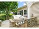 Stainless steel grill built into a stone counter in outdoor kitchen at 606 Corrigan Way, Cary, NC 27519