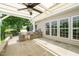 Outdoor kitchen with a stone counter, built-in grill, and view of the back yard at 606 Corrigan Way, Cary, NC 27519