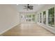 A sunroom features hardwood floors, recessed lighting, and many windows overlooking the outdoors at 606 Corrigan Way, Cary, NC 27519