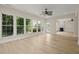 A sunroom features hardwood floors, recessed lighting, many windows, and a ceiling fan at 606 Corrigan Way, Cary, NC 27519