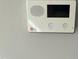 Wall-mounted security panel with emergency, home, and assistance buttons for home safety at 606 Corrigan Way, Cary, NC 27519