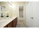 Bright bathroom with a double sink vanity, granite countertops, and a view into the bathtub/shower room at 617 Woodson Dr, Clayton, NC 27527