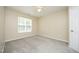 Neutral bedroom with carpet, ceiling fan, and a window providing natural light at 617 Woodson Dr, Clayton, NC 27527