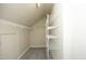 Walk-in closet features built-in shelving, rod, and neutral carpet at 617 Woodson Dr, Clayton, NC 27527