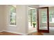 View through the doorway to an enclosed porch with a patterned rug at 617 Woodson Dr, Clayton, NC 27527