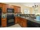 Well-equipped kitchen with modern appliances and wooden cabinets, with an open view into the dining area at 617 Woodson Dr, Clayton, NC 27527