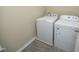 Laundry area with a white washing machine and dryer at 617 Woodson Dr, Clayton, NC 27527