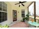 Covered porch with a ceiling fan, green furniture and plants at 617 Woodson Dr, Clayton, NC 27527