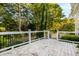 White backyard deck with black railing overlooks the wooded yard and is perfect for entertaining at 6201 King Croydon Ct Ct, Raleigh, NC 27603